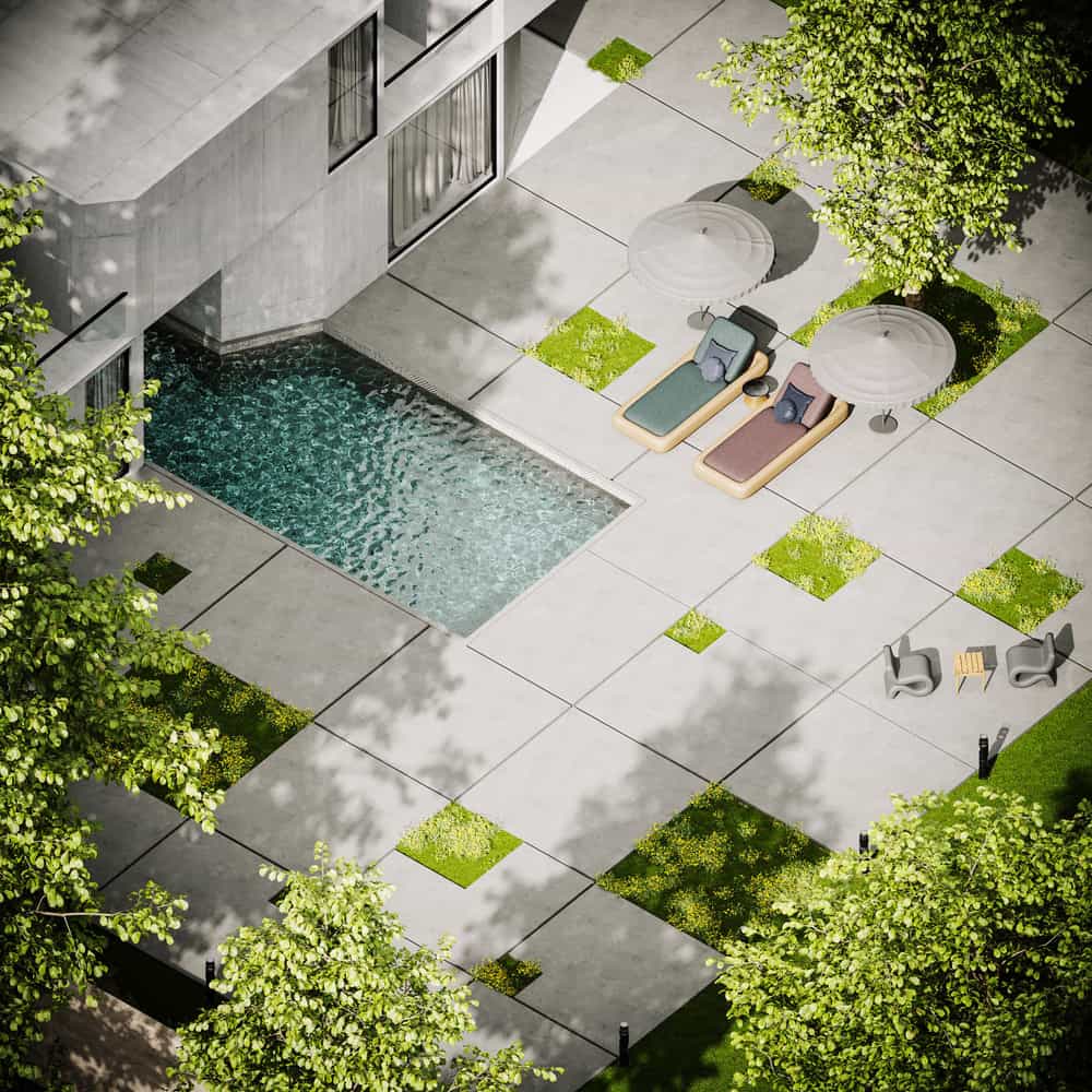 Illustrative stock photo: lounge chairs on a sunny patio beside a pool and trees
